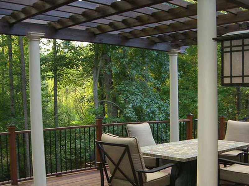 Exterior Design + Decks built pergola in North Atlanta with a wooden deck and seating area